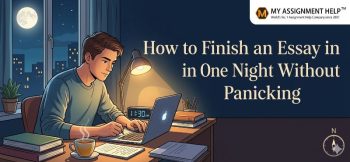 Student writing a term paper on a laptop at a desk at night with a lamp on and the MyAssignmentHelp logo.